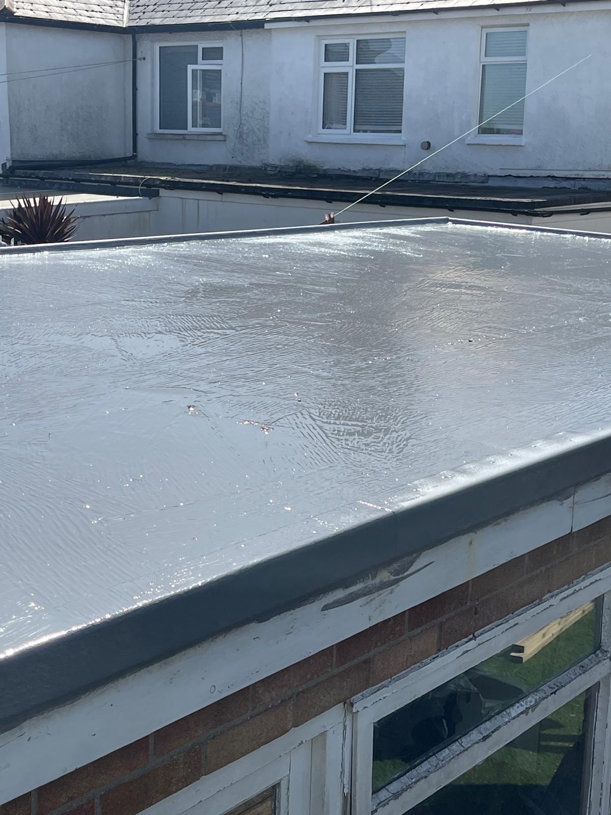 New grey GRP flat roof on a rear extension