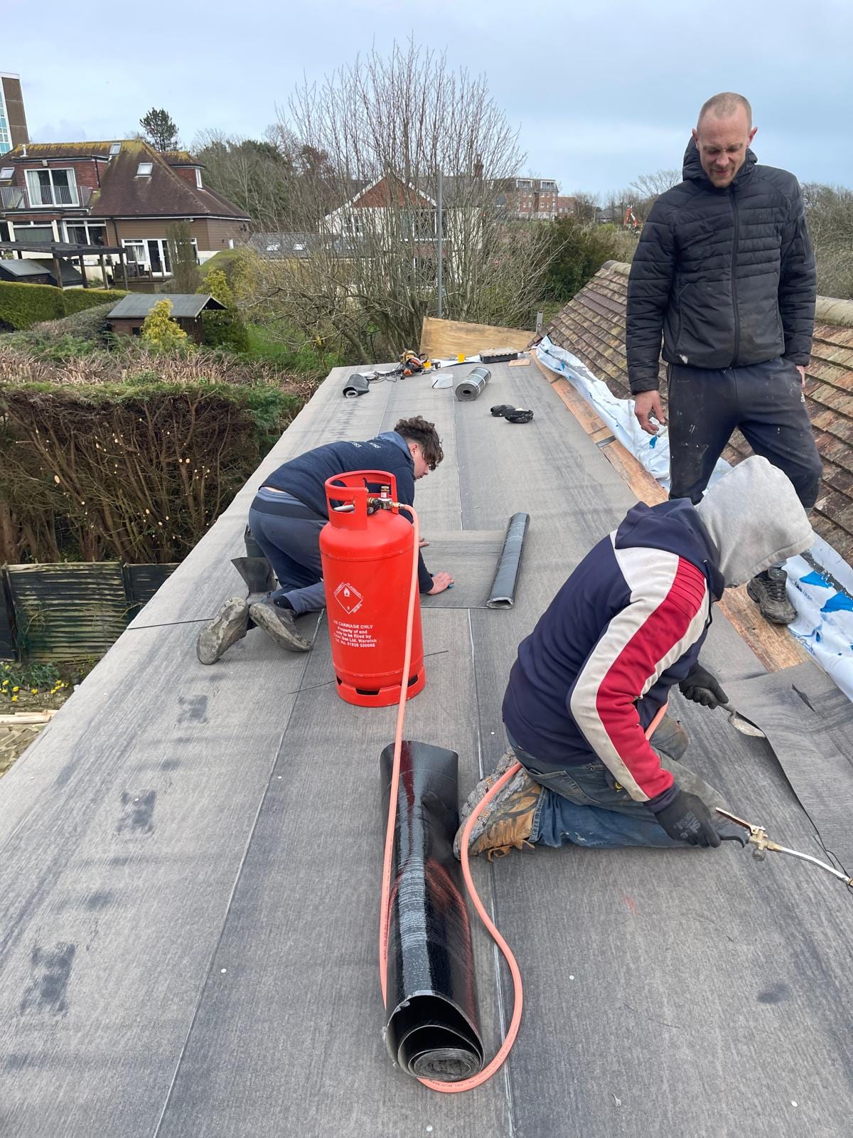 ASAP roofer torching on a new felt membrane